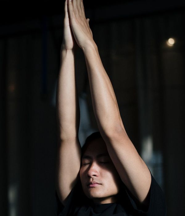 A man in deep concentration during a stretching exercise.